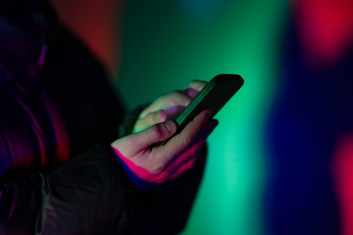 Photo of hand holding a smartphone